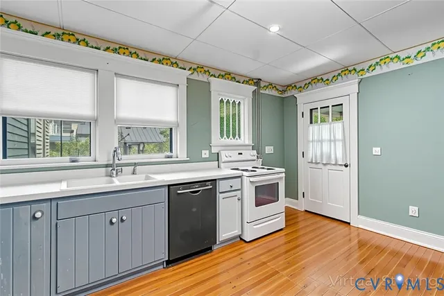 a kitchen with a sink stove and cabinets