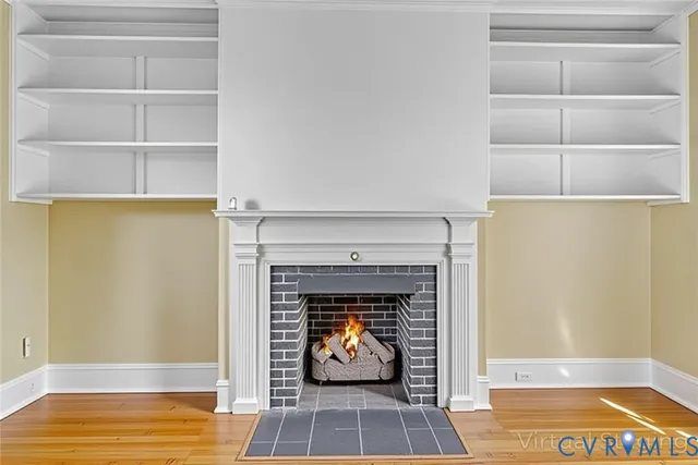 a living room with a fireplace and a rug