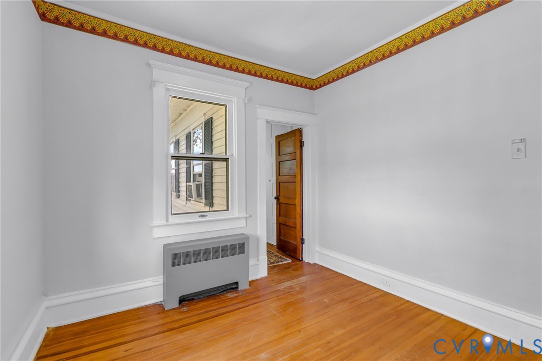 218 Fleeton Point Circle Reedville, VA 22539 - Photo 35 of 43 Spare room with radiator, hardwood / wood-style fl