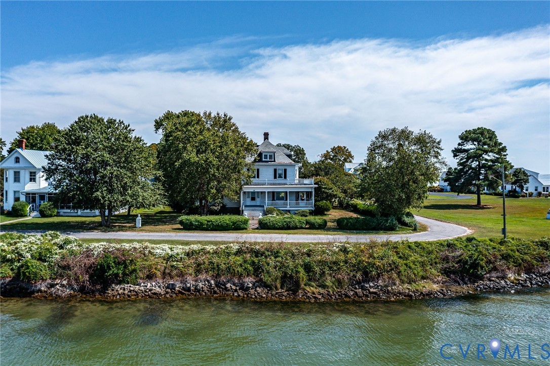 218 Fleeton Point Circle Reedville, VA 22539 - Photo 43 of 43 Back of house featuring a water view, a chimney, a