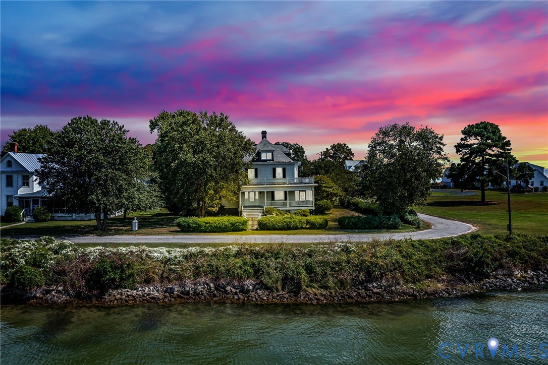 218 Fleeton Point Circle Reedville, VA 22539 - Photo 7 of 43 Back of house at dusk with a water view, a porch,
