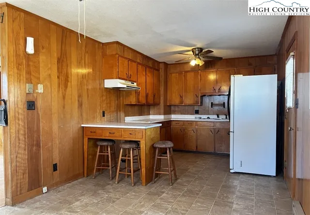 a kitchen with a sink appliances and cabinets