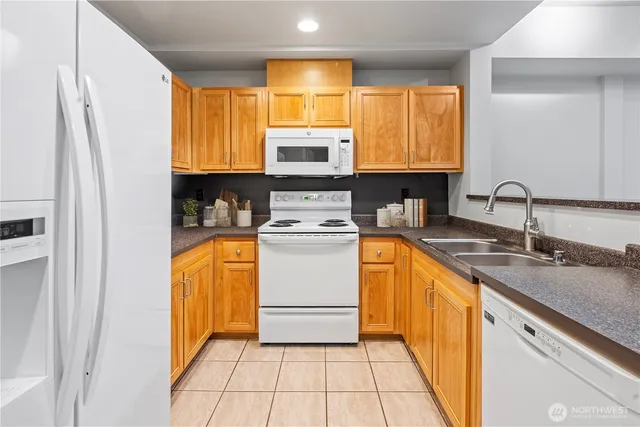 a kitchen with a sink a stove top oven and cabinets