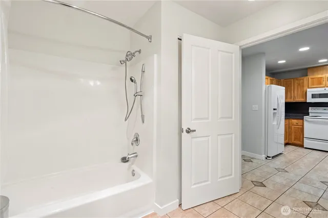 a bathroom with a bathtub and a shower