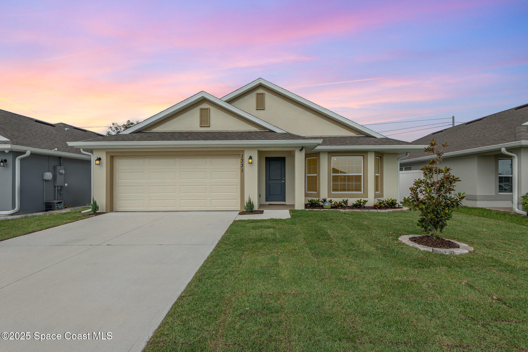 1331 Tupelo Circle Cocoa, FL 32926 - Photo 1 of 29 a front view of a house with a garden and yard