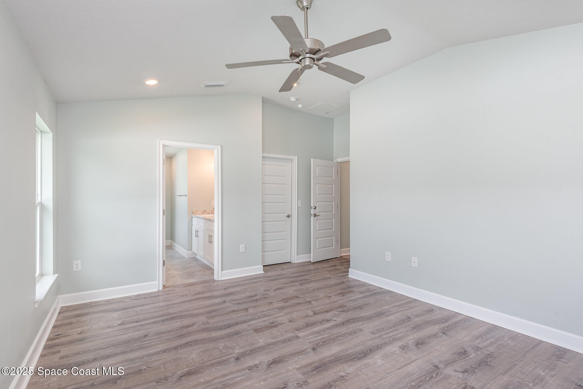 1331 Tupelo Circle Cocoa, FL 32926 - Photo 11 of 29 an empty room with wooden floor and fan