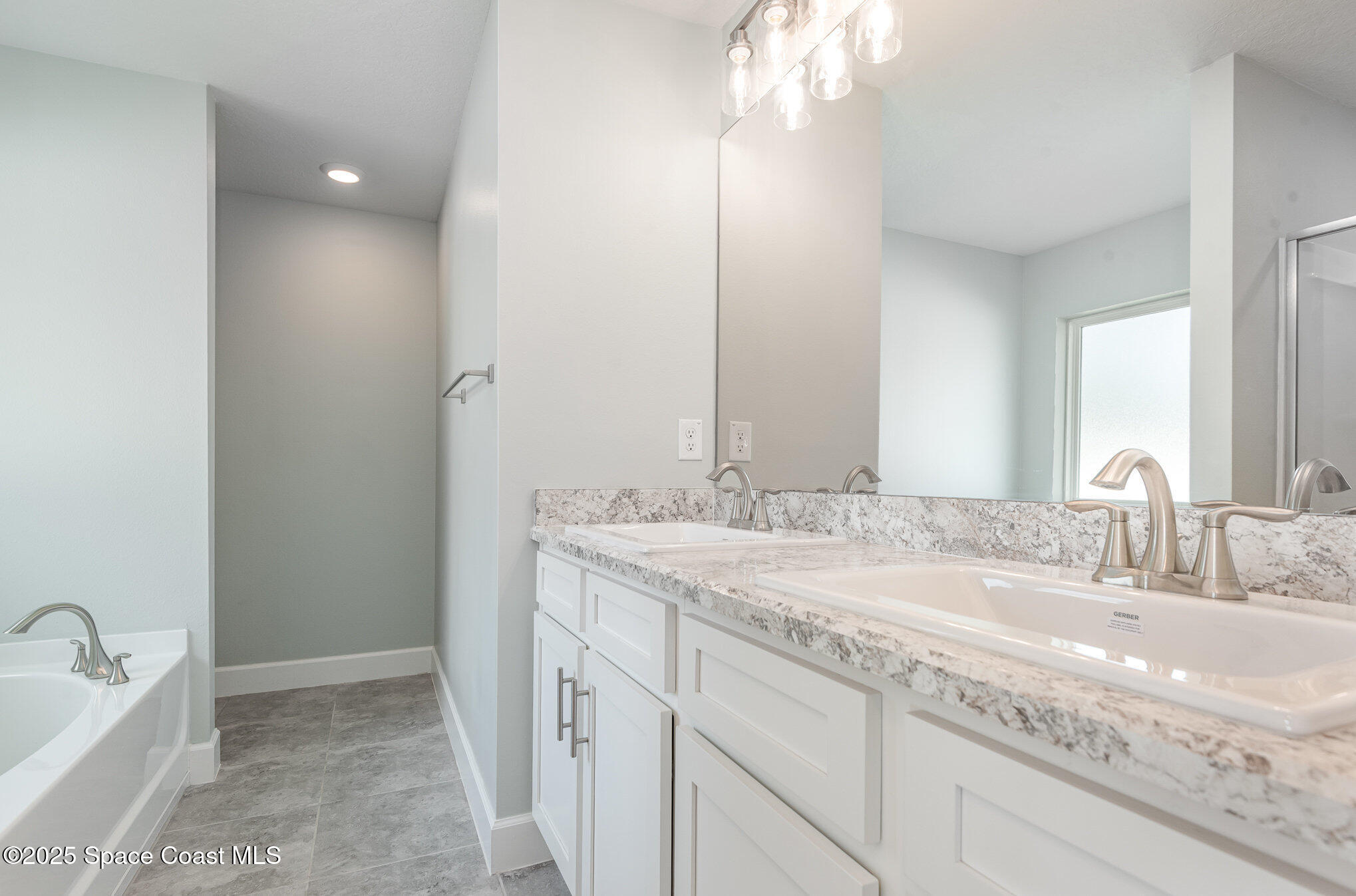 1331 Tupelo Circle Cocoa, FL 32926 - Photo 12 of 29 a bathroom with a granite countertop sink and a mirror