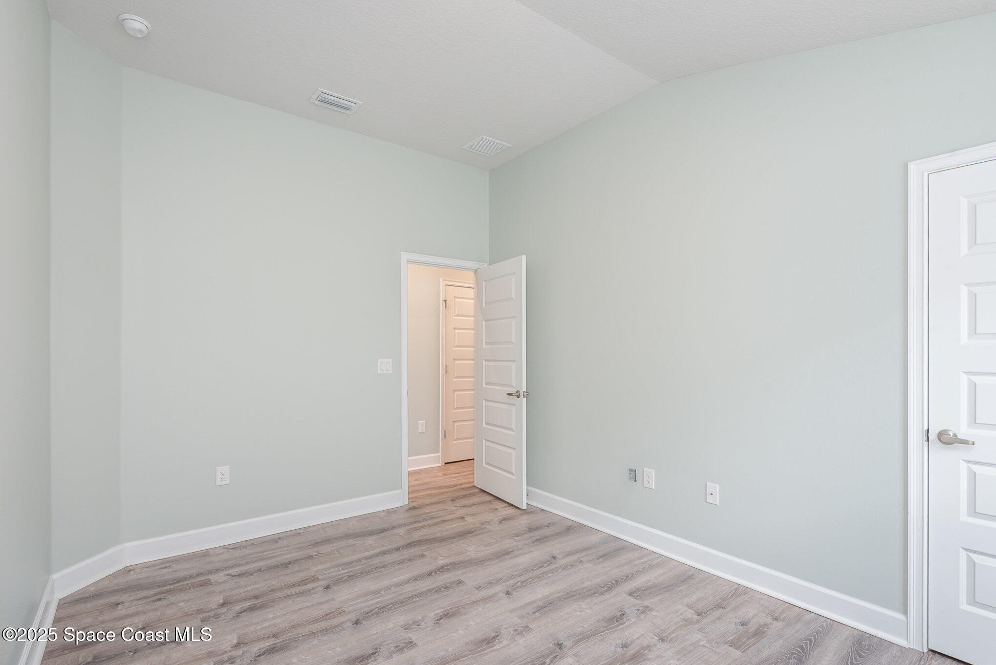 1331 Tupelo Circle Cocoa, FL 32926 - Photo 16 of 29 a view of an empty room with wooden floor