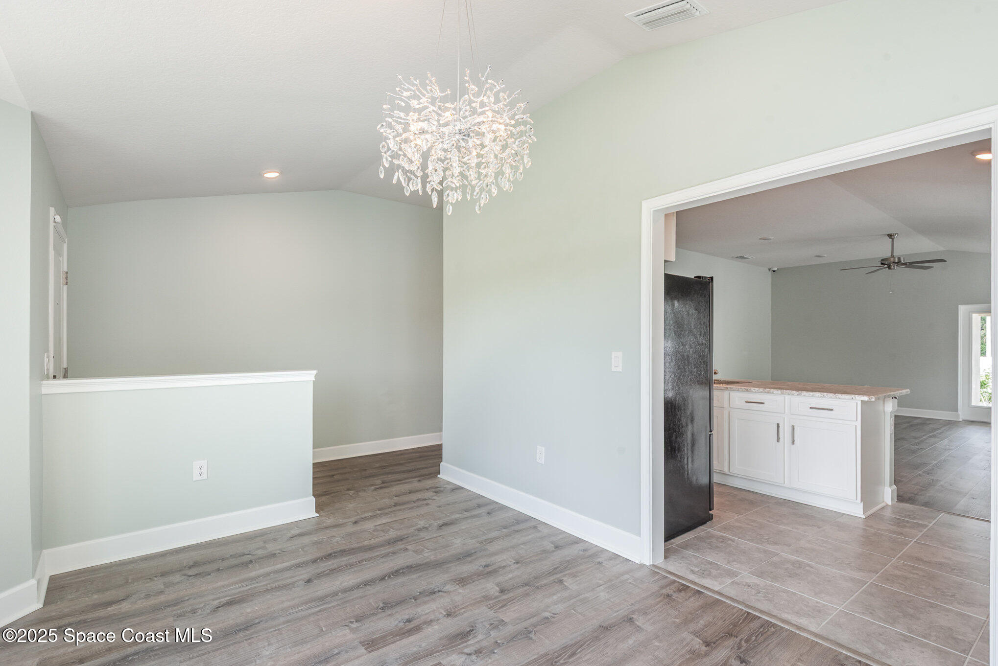 1331 Tupelo Circle Cocoa, FL 32926 - Photo 3 of 29 wooden floor in an empty room with a window