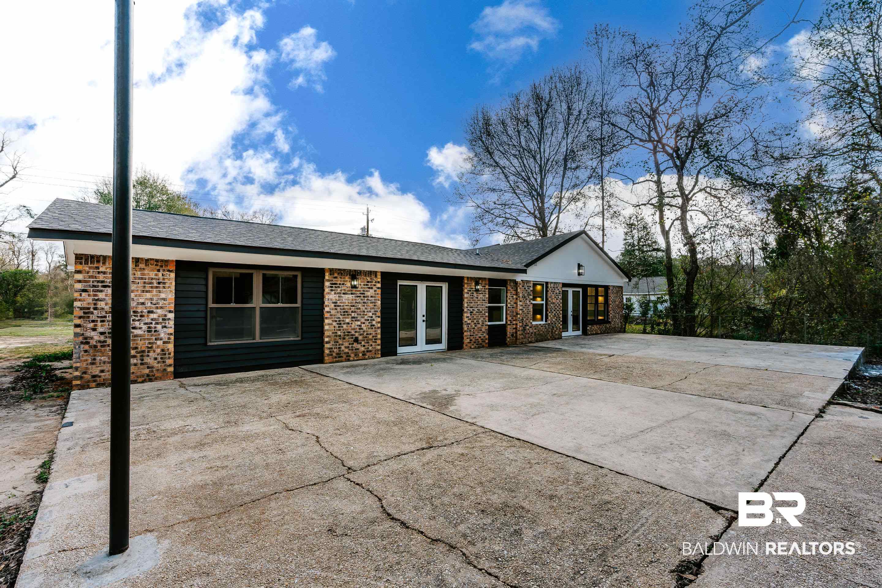 1190 Military Road Mount Vernon, AL 36560 - Photo 40 of 47 Back of property featuring french doors, brick siding, a shingled roof, and a patio area