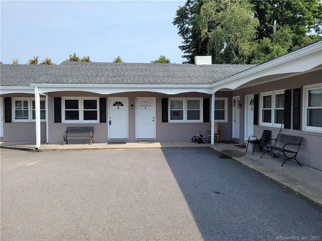 front view of a house with a garden and patio