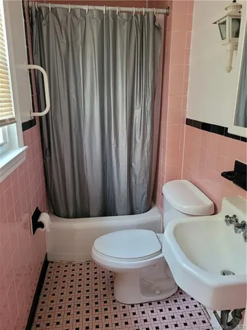 a bathroom with a toilet a sink and a shower