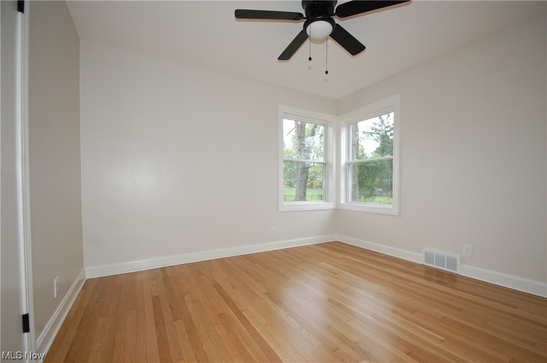 408 Ewing Road Youngstown, OH 44512 - Photo 16 of 31 Wood floored spare room featuring ceiling fan