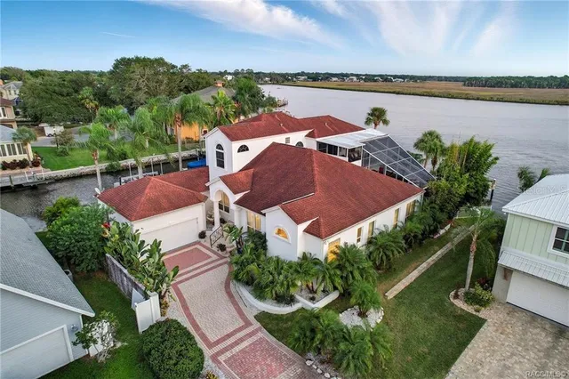 an aerial view of residential houses with outdoor space and lake view
