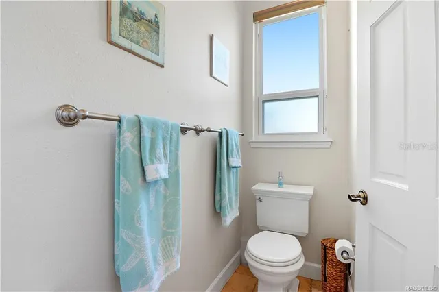 a view of a balcony with floor to ceiling windows and potted plants