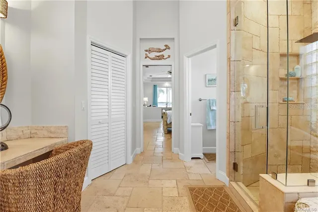 a living room with furniture and a view of kitchen