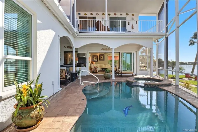a view of a livingroom with a chandelier closet and windows