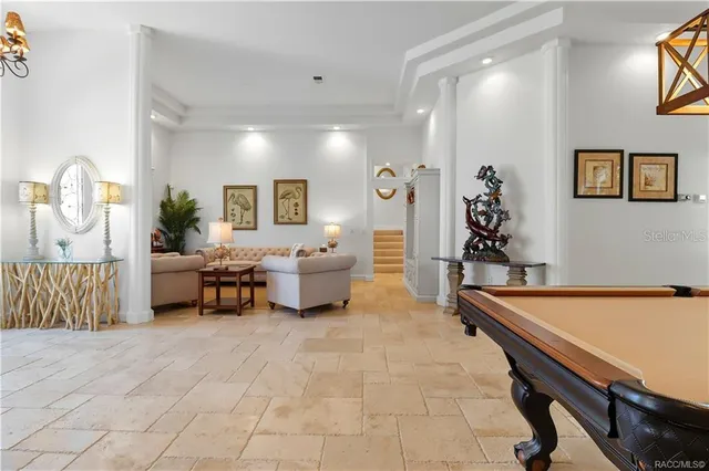 a living room with furniture chandelier and a window