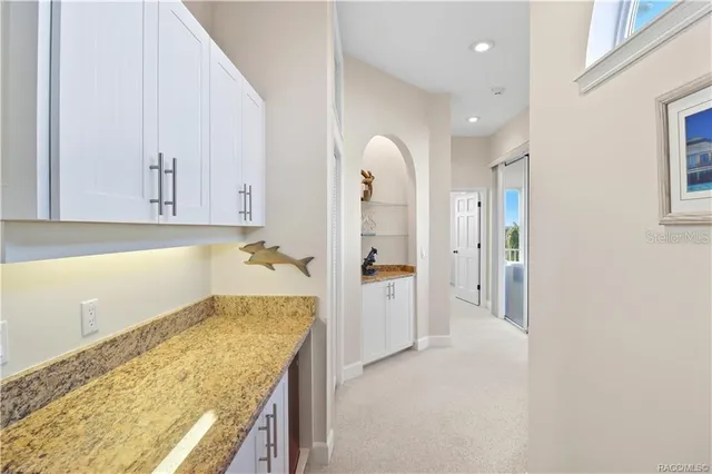 a view of a lake with a house swimming pool patio and swimming pool