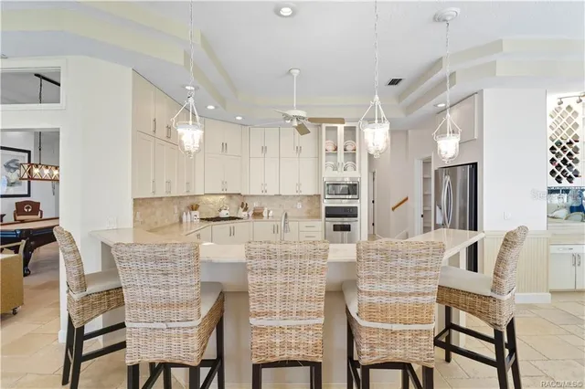 a living room with furniture a flat screen tv and a large window