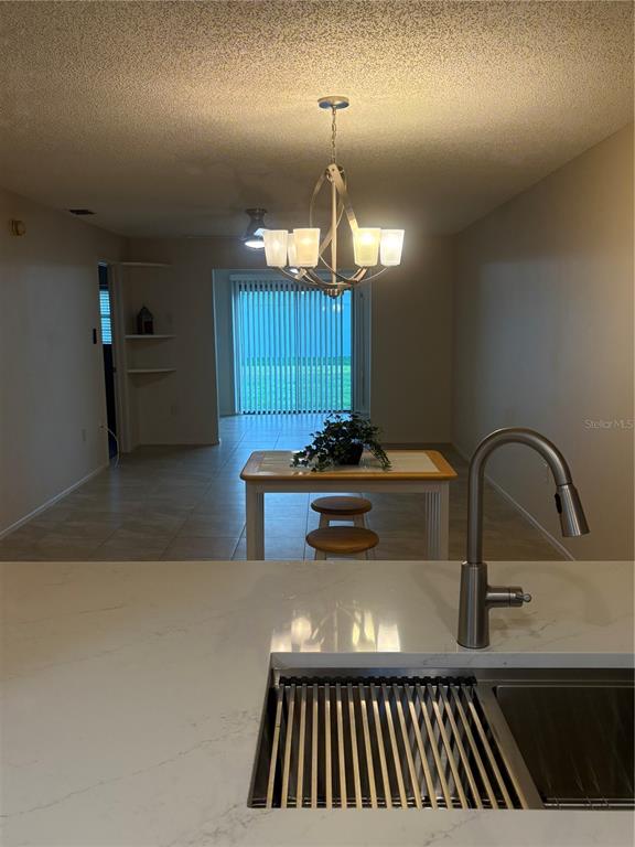 13250 Ridge Road, Unit 16 Largo, FL 33778 - Photo 13 of 36 a view of a kitchen with a sink and chandelier