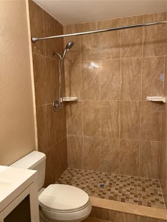 a bathroom with a shower and a toilet