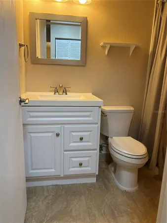 a bathroom with a sink a toilet and bathtub