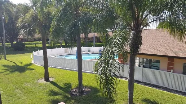 a view of a house with pool yard and lake view