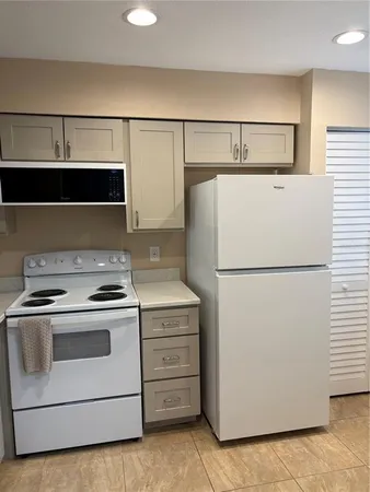 a stove top oven sitting inside of a kitchen