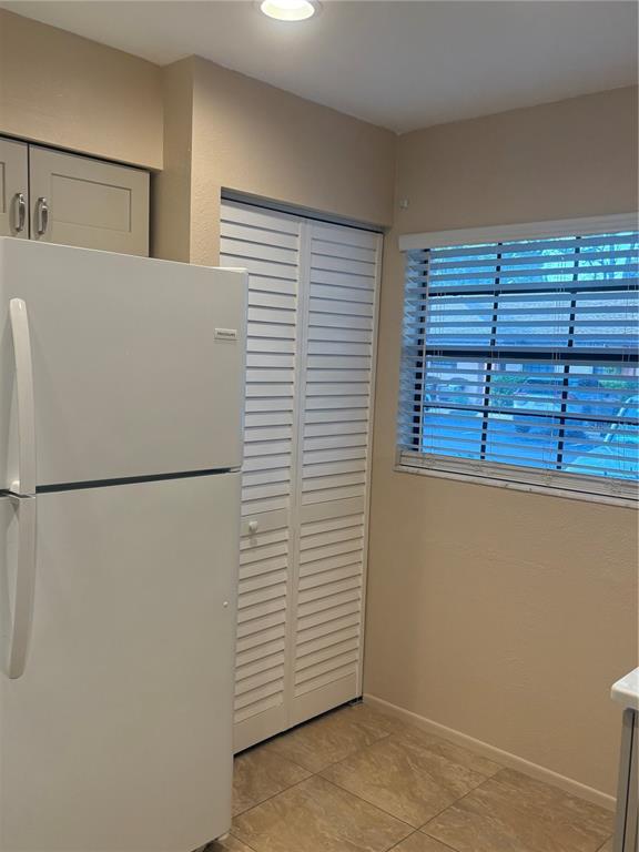 13250 Ridge Road, Unit 16 Largo, FL 33778 - Photo 9 of 36 a white refrigerator freezer sitting inside of a kitchen