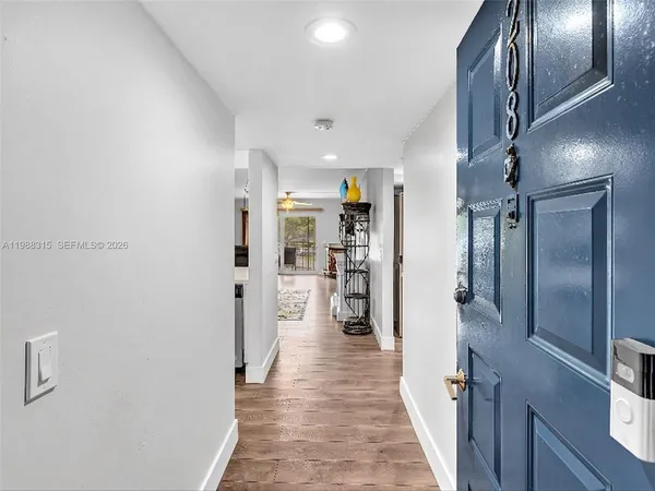 a view of a hallway with wooden floor