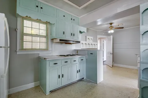 a kitchen with stainless steel appliances granite countertop a sink a window and cabinets