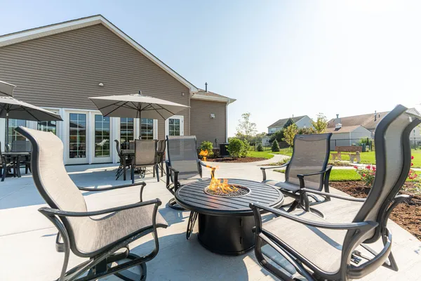 a view of a patio with table and chairs and potted plants