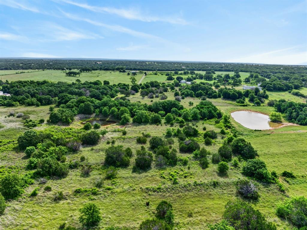 Lot 28 Fairview Road Mineral Wells, TX 76067 - Photo 8 of 16 a view of a green field with lots of trees