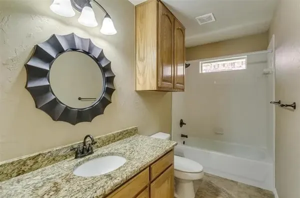 a bathroom with bathtub and window