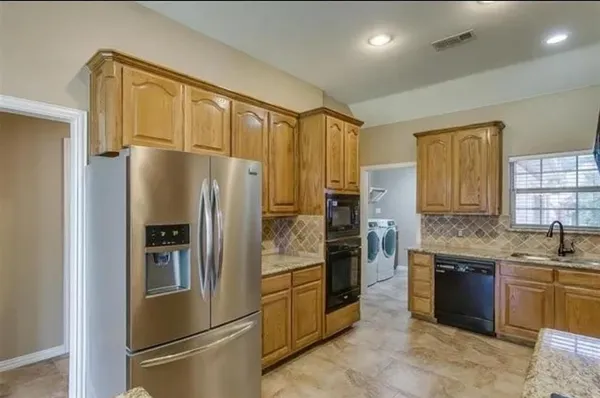 a kitchen with granite countertop a sink and a stove