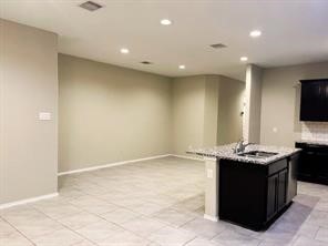 8310 Rose Petals Lane Rosharon, TX 77583 - Photo 8 of 31 The open dining area offers plenty of space for a full-size dining table and enjoys a seamless connection to the kitchen, making everyday meals and entertaining effortless.