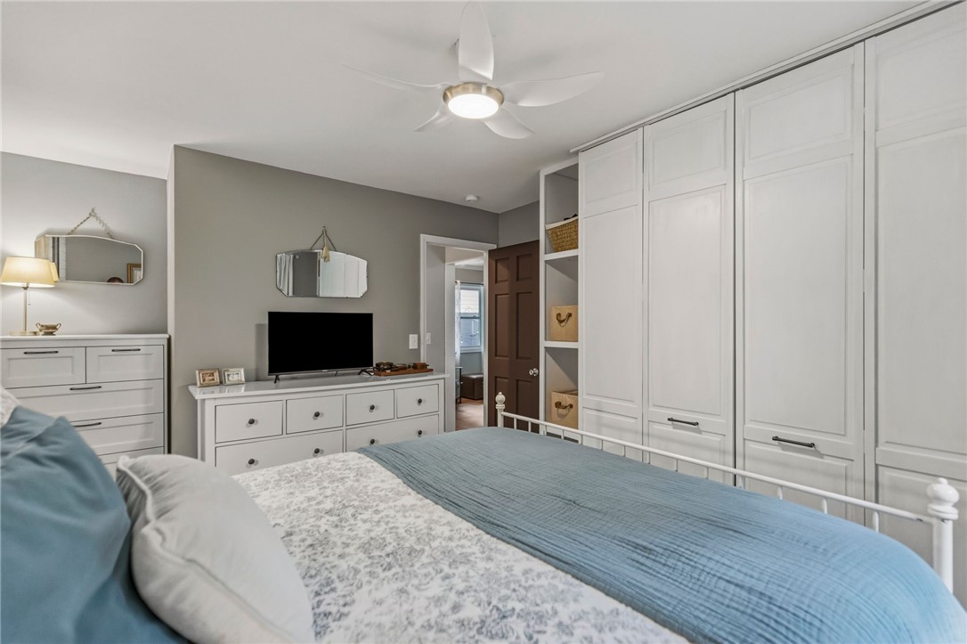 641 Lands End Road Seneca, SC 29678 - Photo 8 of 39 Custom built-in wardrobe storage and a ceiling fan create a comfortable, organized bedroom retreat.