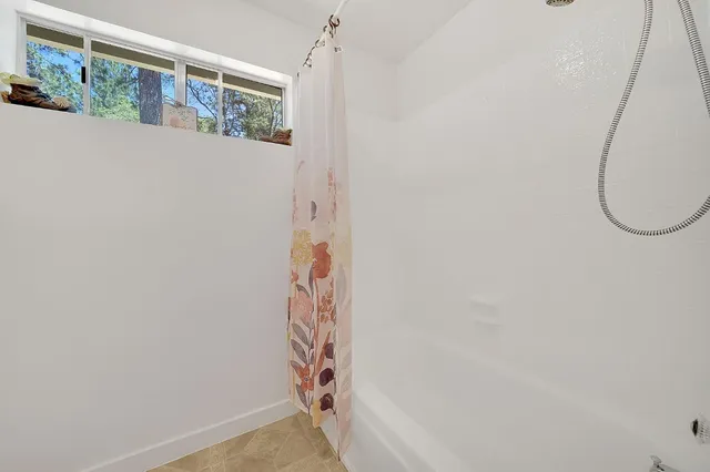 a spacious bathroom with a bathtub and a toilet