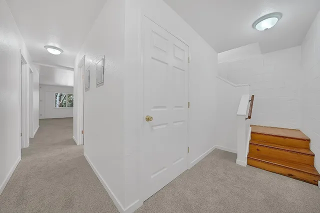 an empty room with a window and ceiling fan