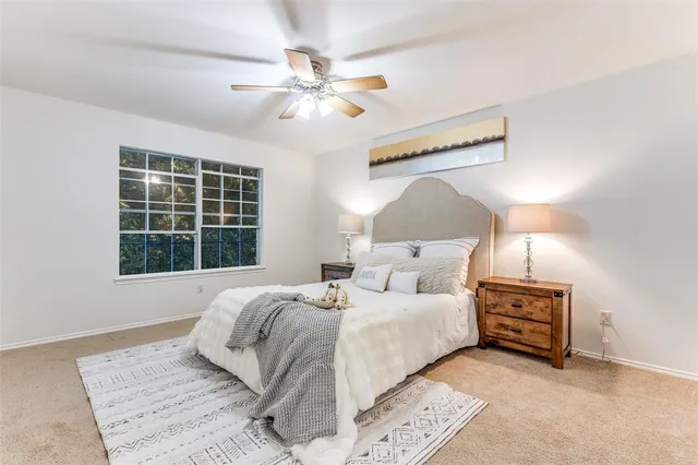 a bedroom with a large bed and a window