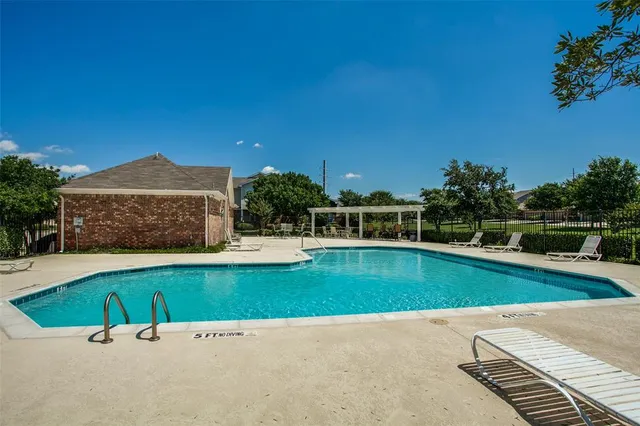 a view of a swimming pool with a yard