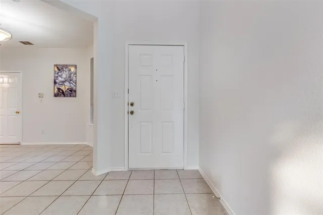 a view of an empty room and painting on the wall