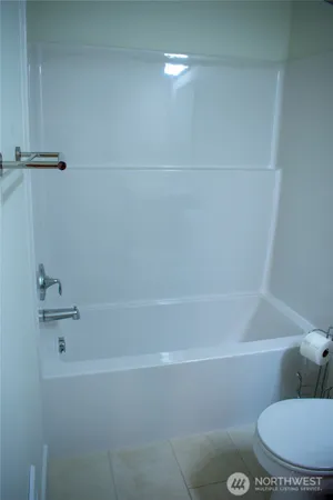 a bathroom with a bathtub and toilet