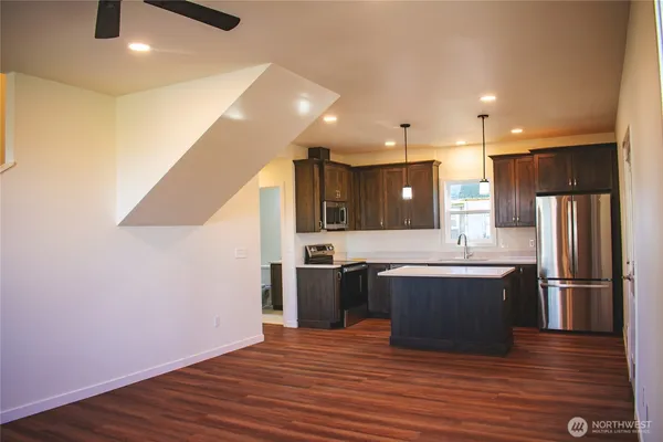 a large kitchen with stainless steel appliances granite countertop a large stove top oven and refrigerator