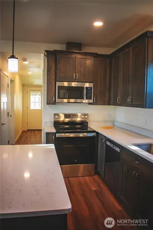 a kitchen with a stove and a refrigerator