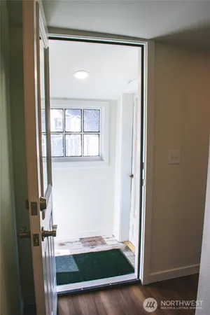 view of an empty room with wooden floor and a window