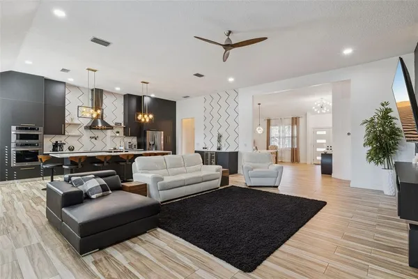 a living room with furniture and a wooden floor