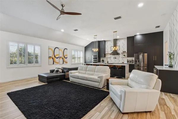 a living room with furniture wooden floor and window