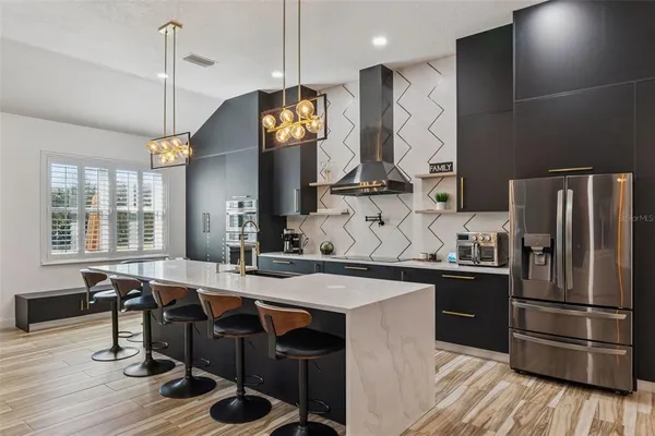 a kitchen with granite countertop a sink a counter space appliances and cabinets